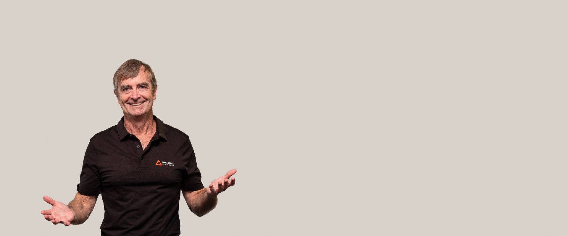 Dane Hudson, founder of Impactful Leadership, in an open-handed leadership posture